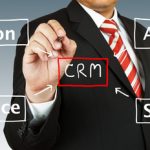 Business man drawing CRM diagram